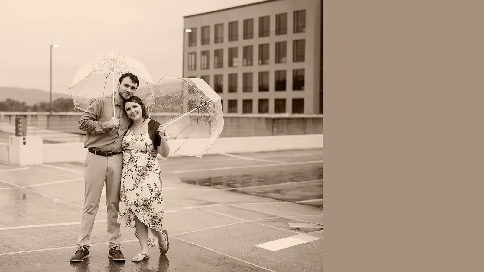 Tianna and her husband posing with umbrellas.