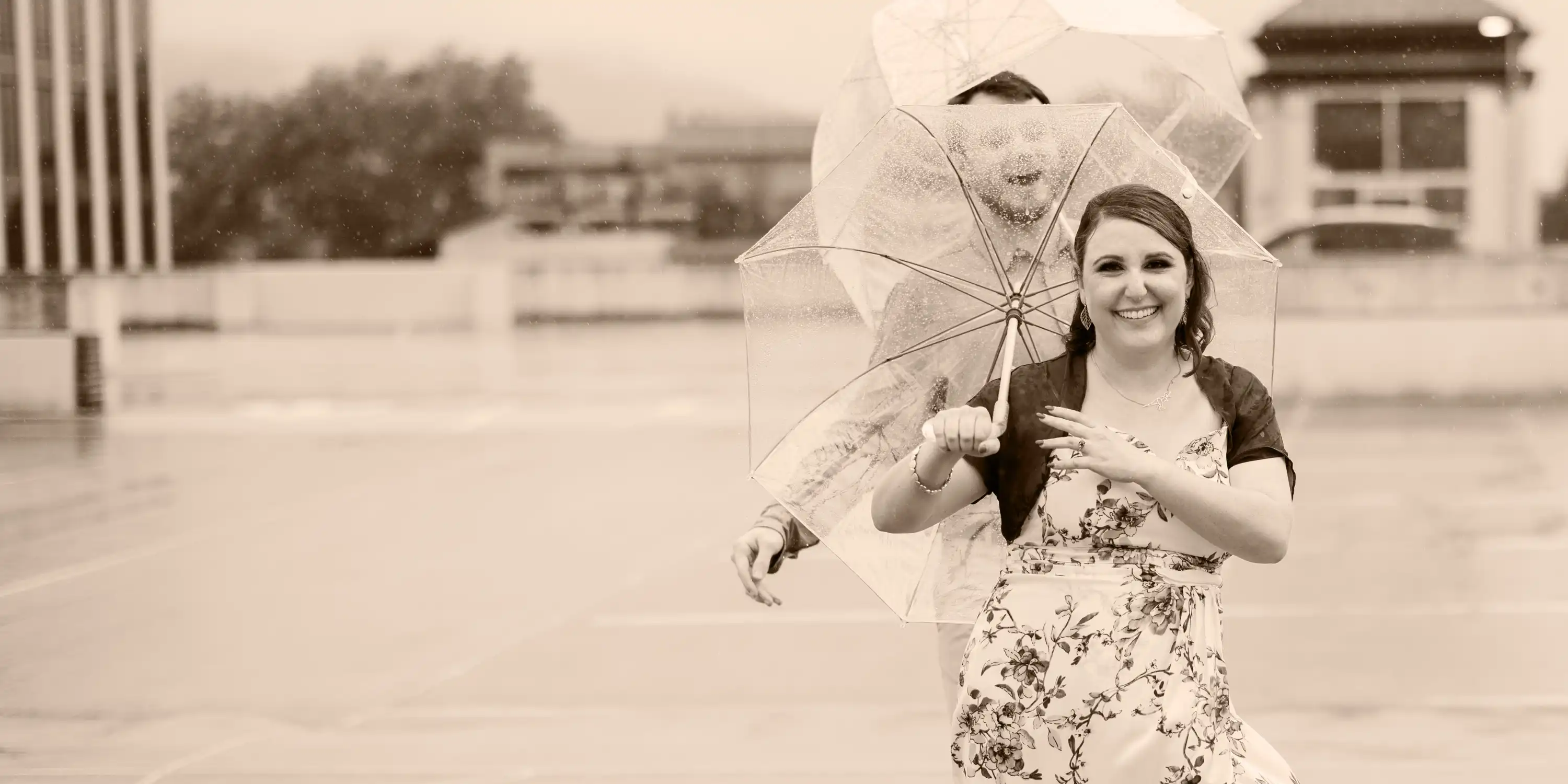 Tianna smiling mid motion while holding an umbrella.