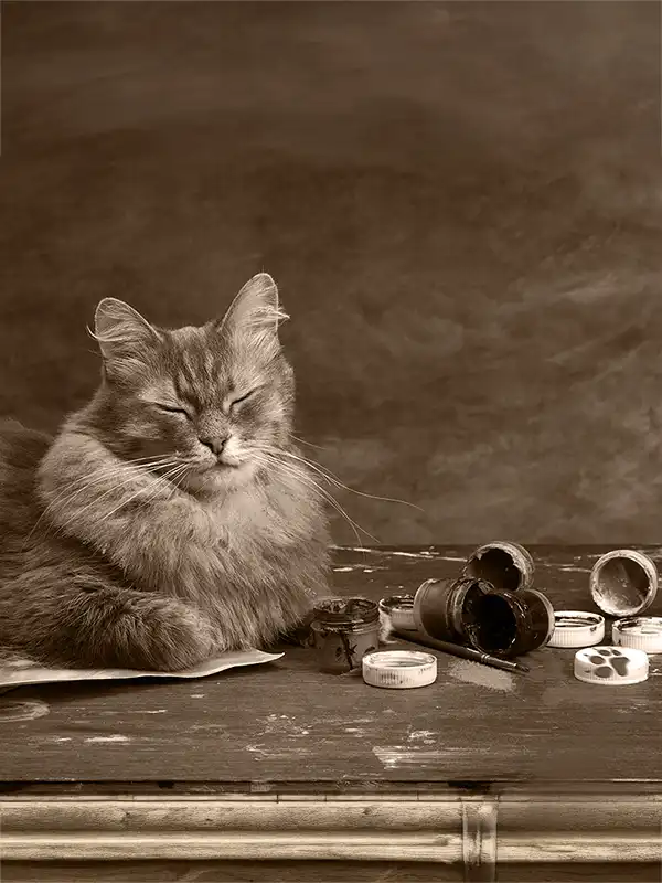 A cat loaing with its eyes closed next to art supplies.