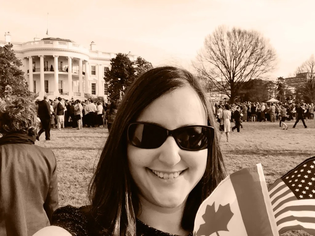 Tianna on the White House South Lawn with American and Canadian flags.